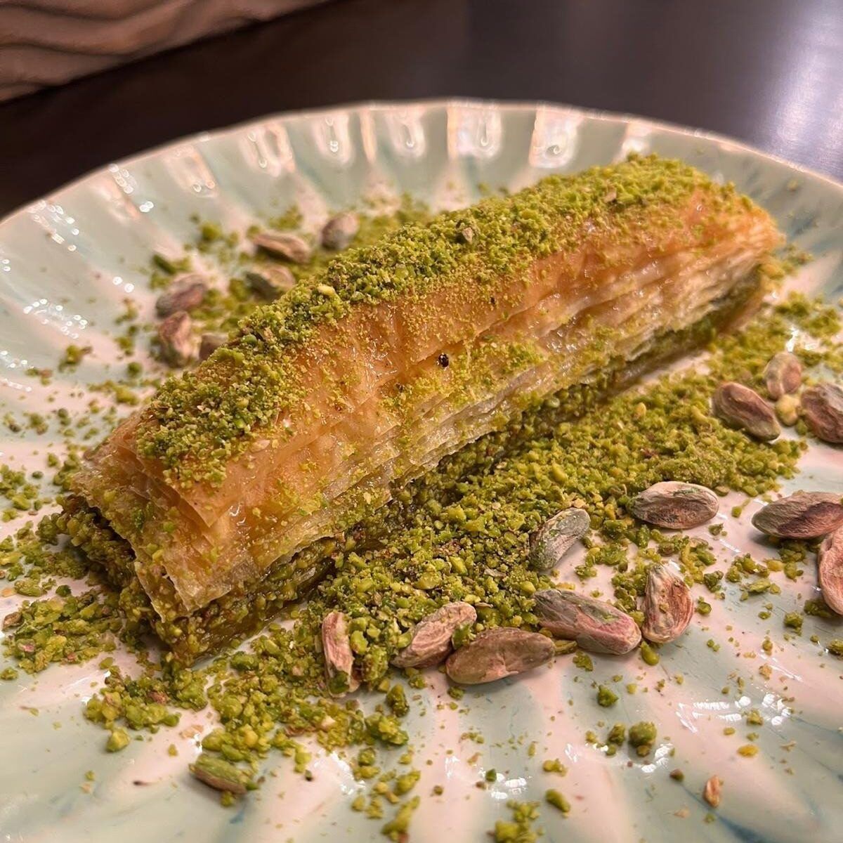 Pistazien-Baklava mit reichlich Pistazienstreu auf einem Teller